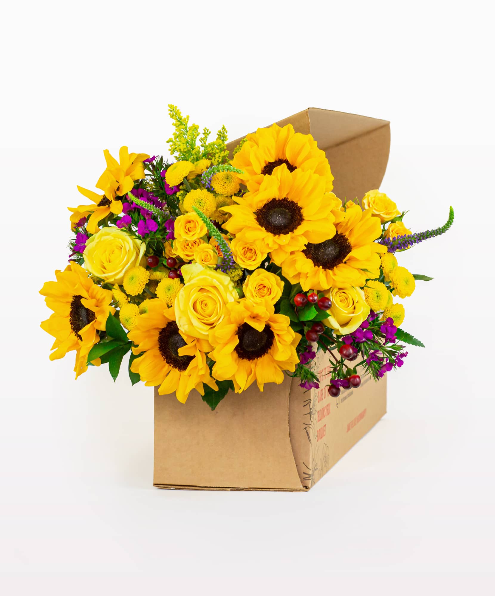 Vibrant bouquet featuring sunflowers, yellow roses, and colorful accents in a decorative box.